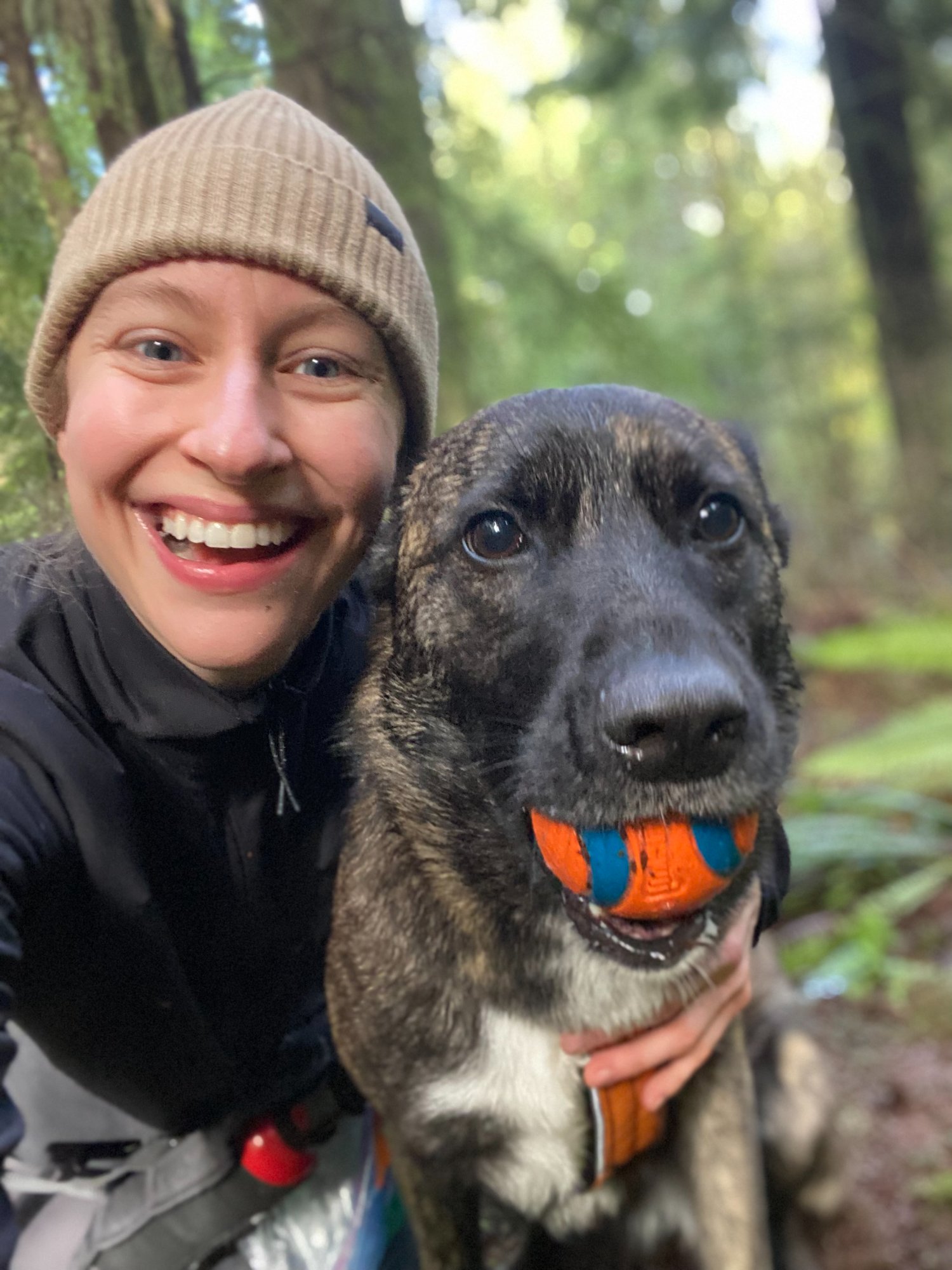 Katia with a dog on a forest trail